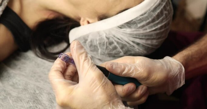 beautiful young woman on a facial dermapen micro-needling treatment at the beauty salon. Woman is getting a facial treatment with a device.