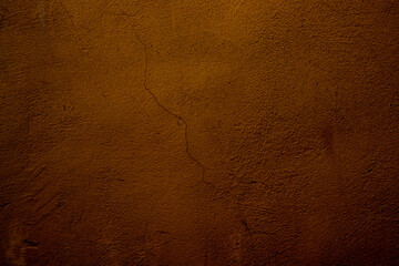 Rustic Brown Textured Wall with Cracks and Subtle Lighting Effect