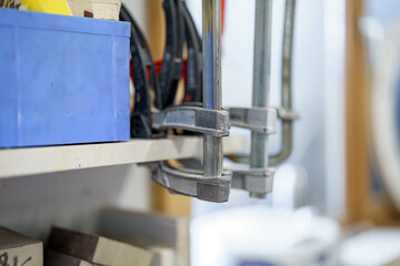 A set of clamps for making furniture in a carpentry workshop. Furniture manufacturing plant.