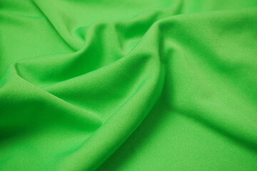 green fabric with ripples and waves texture background
