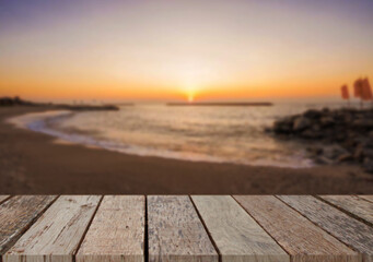 Wooden table top on the beach or sea.Party on the beach  sunset time concept.For montage product display or design key visual layout.View of copy space.