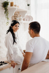 Fototapeta premium young couple guy and girl in a large kitchen