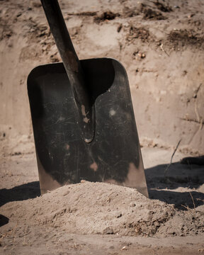 a shovel rakes sand