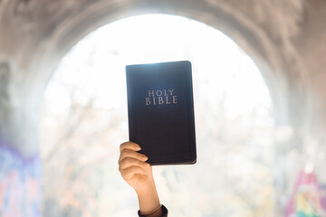 Bible in Girl's Hand: Choosing to Believe in God