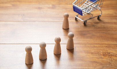 Shopping cart with a wooden human figures.