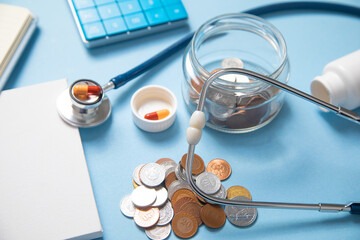 Jar of coins, stethoscope, calculator, pills.