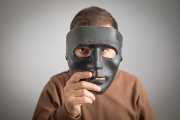 Caucasian man with a black mask.