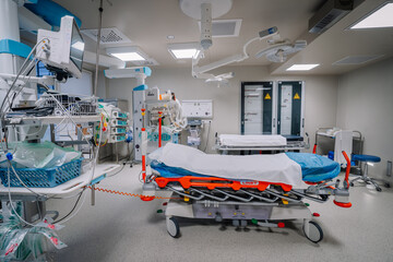 A modern hospital operating room with advanced medical equipment, patient beds, monitors, and surgical tools, ready for procedures..