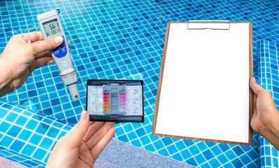 Swimming pool water testing test kit with blank report paper on wooden clipboard over clear pool...