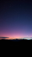 Fototapeta premium Stunning Night Sky Wallpaper Featuring a Silhouette of a Lone Traveler Staring at the Milky Way, Illuminated by a Deep Purple and Blue Gradient with Glittering Stars and a Peaceful Mountain Horizon