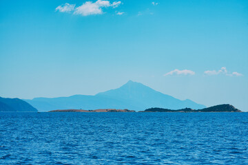Calm sea, silhouetting distant mountains of Athos ,Greece 