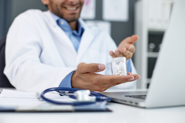 doctor's hand holding a bottle of pills close-up