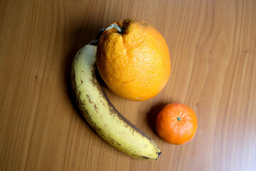 Colorful fruits arranged on a wooden table in natural light