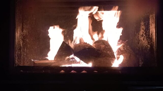 The fire is burning in the fireplace.