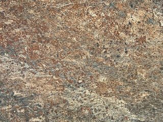 Close up of rusty and weathered granite stone texture, suitable for outdoor and exterior flooring. Oxidized, copper and grey color. Seamless stone background texture.