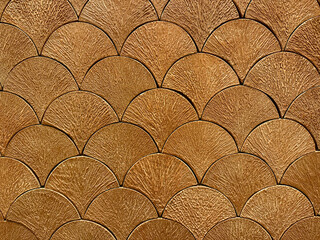 Texture of Japanese fish scales or Chinese fish skin wave and curve pattern. Asian curved fan and fish scales pattern, in golden brown color. Seamless background texture.