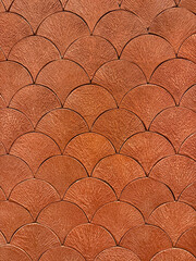 Texture of Japanese fish scales or Chinese fish skin wave and curve pattern. Asian curved fan and fish scales pattern, in brown red color. Seamless background texture. © TMR Studio