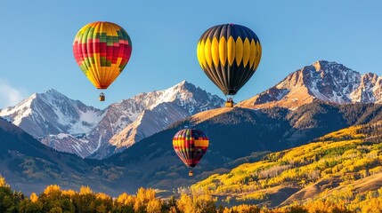 Fototapeta premium Hot Air Balloons Floating Over Majestic Autumn Mountain Landscape