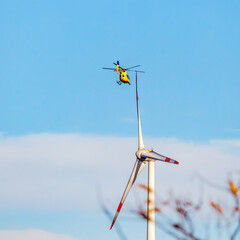 wind turbine in the sky. rescue helicopter close above a wind turbine © ImageSine