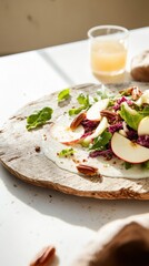 Colorful salad with apple slices and pecans on a rustic plate