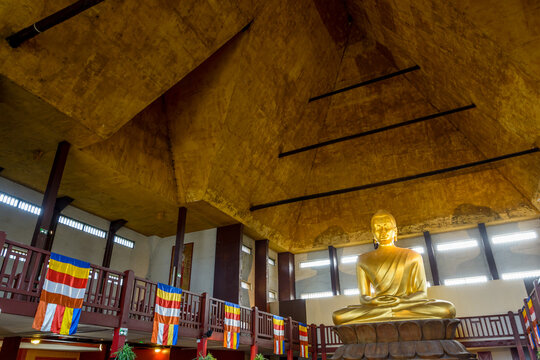 Paris, France - April 8, 2018: The 10 meters tall golden statue of Buddha in a Lotus pose, work of sculptor Francois Mozes sited in the Great Pagoda of the Bois de Vincennes, is the tallest in Europe.