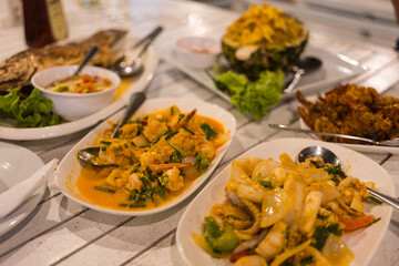 Classic Thai seafood dishes on table dinner sharing a variety of freshly served dishes in the restaurant