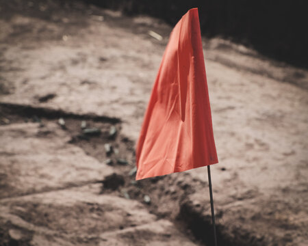recording of an archaeological find (orange flag on the ground)