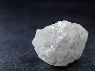 Close-up of quartz mineral on gray background