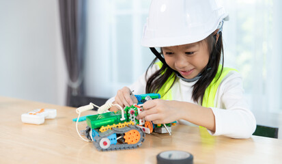 Young girl working on a robot design in Robotics programming class. STEM education using constructor blocks and laptop, Technology educational development for school kids