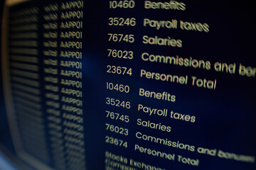 Extreme close up on computer screen displaying orange lines of coding program on black background, fish eye effect