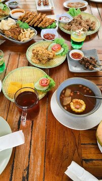 Sundanese cuisine, is the cuisine of the Sundanese people of Western Java, and Banten, Indonesia. Pictured here,fried chicken, Sambal, karedok or vegetable salad, fried tempeh, satay and fried fish.
