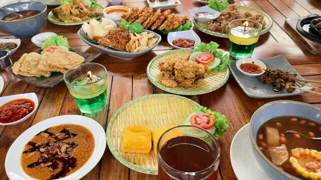 Sundanese cuisine, is the cuisine of the Sundanese people of Western Java, and Banten, Indonesia. Pictured here,fried chicken, Sambal, karedok or vegetable salad, fried tempeh, satay and fried fish.

