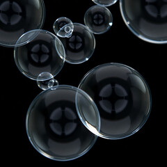 Floating soap bubbles on black background