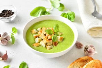 Spinach soup with croutons in  bowl