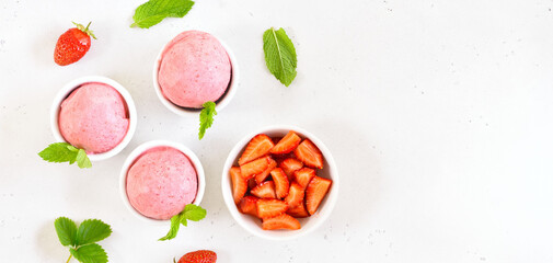 Strawberry ice cream scoops in bowl