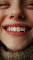 Close-up portrait of a smiling woman, showcasing her radiant smile and healthy skin.