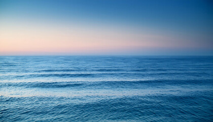 Obraz premium Tranquil Ocean Scene Under a Clear Sky: A Serene and Minimalistic Wallpaper Showcasing Gently Rippling Waves and a Soft Gradient Horizon at Sunset