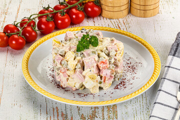 Russian traditional Olivier salad with sausages