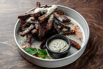 A plate of crispy garlic croutons, garnished with herbs and served with a flavorful dipping sauce....