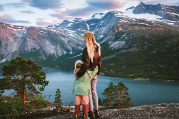 Child and mother walking in mountains hugging family travel in Norway, mom and daughter hiking together active vacations outdoor enjoying landscape, Mothers day holiday