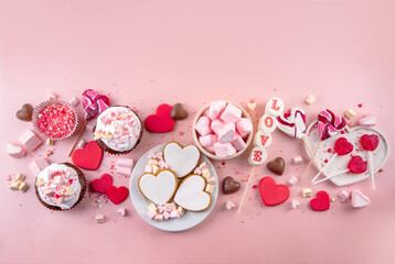 Valentines day heart shaped cookies, candies, chocolates, sweets, cupcakes marshmallow, holiday decorations on bright red pink background top view copy space. Valentine`s party menu, invitation flat l