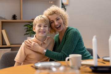 Obraz premium Happy Mother and Son Smiling Together in a Modern Home Setting