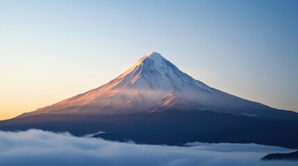 Fototapeta premium Majestic Mount Fuji at Sunrise with Soft Clouds in Foreground and Serene Blue Sky, Captivating Winter Landscape in Vibrant Colors