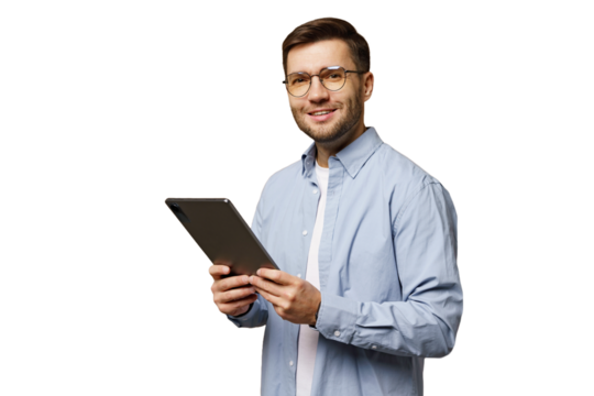 Man holding a tablet while smiling in a studio setting with a plain background