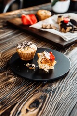 Tiny muffins on a matte black plate, showcasing rich textures and colors