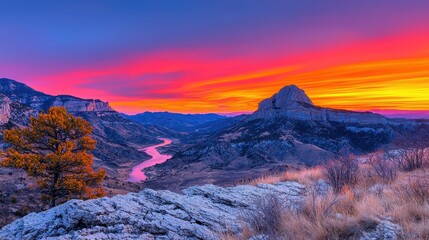 Obraz premium Flowing river carving through a rugged canyon landscape at sunset nature photography scenic environment panoramic view