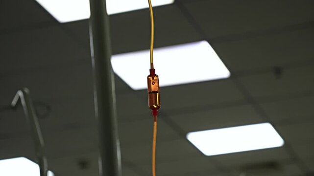 Saline IV Drip: Intravenous drip fluid administered in a hospital room. Medical concept encompassing treatment emergencies, injection drug infusion, care, therapy, and chemotherapy.
