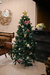 beautiful christmas tree decoration with red gold bulbs and ornaments isolated for small room interior details