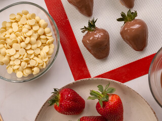 the process of making chocolate-covered strawberries, chocolate-covered strawberries are stabilized on a pastry mat
