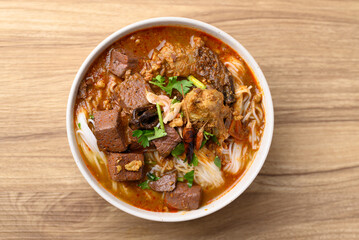Northern Thai food, Spicy rice noodles soup on wooden background, Local Thai food
